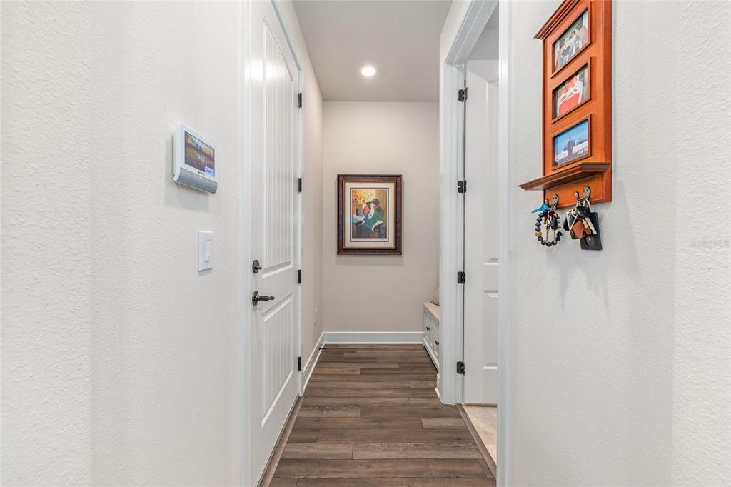 8986 Southwest 58th Street Road Ocala, FL 34481 - Photo 30 of 53 a view of a hallway with paintings on the wall