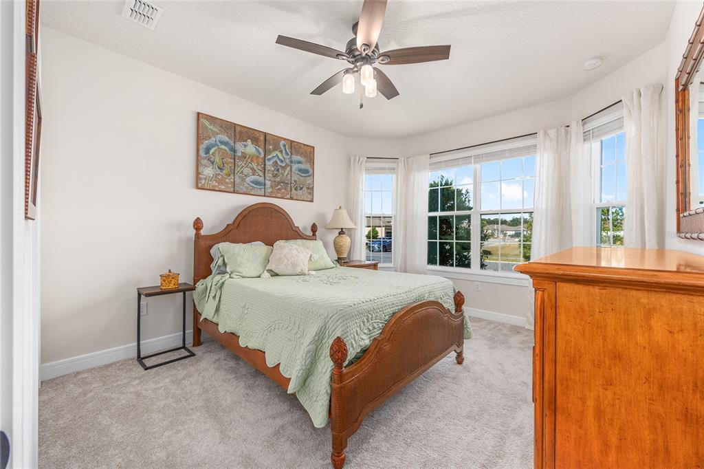 8986 Southwest 58th Street Road Ocala, FL 34481 - Photo 3 of 53 a spacious bedroom with a bed and a large window