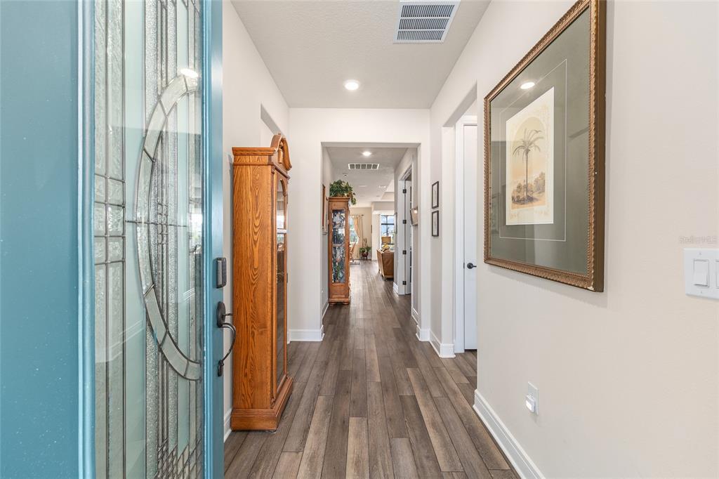 8986 Southwest 58th Street Road Ocala, FL 34481 - Photo 8 of 53 a view of a hallway with wooden floor and staircase