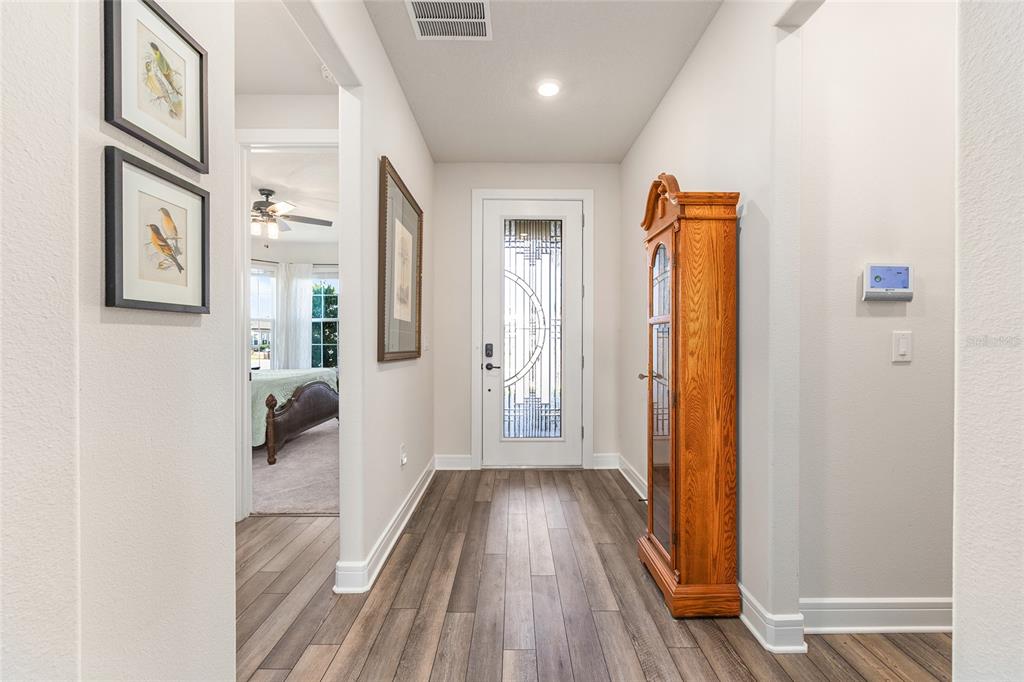 8986 Southwest 58th Street Road Ocala, FL 34481 - Photo 9 of 53 a view of a hallway with wooden floor and staircase