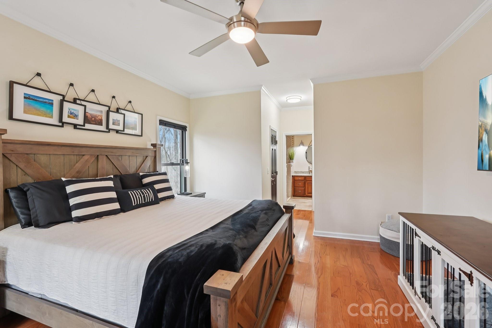 11655 Terrill Ridge Drive Davidson, NC 28036 - Photo 15 of 40 a bedroom with a bed and a chandelier