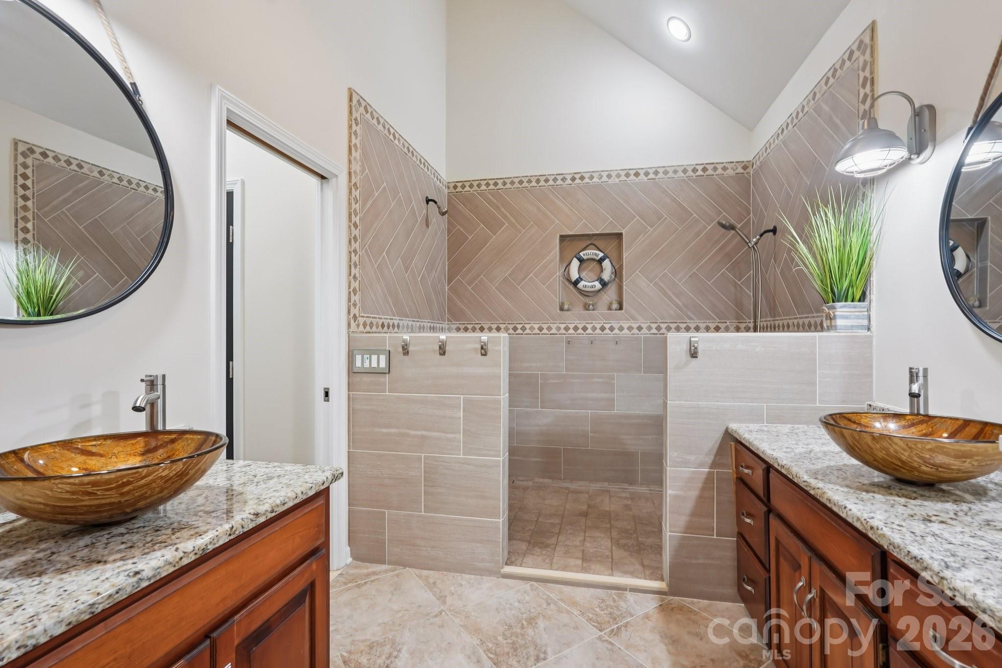 11655 Terrill Ridge Drive Davidson, NC 28036 - Photo 16 of 40 a bathroom with a granite countertop sink a mirror and shower