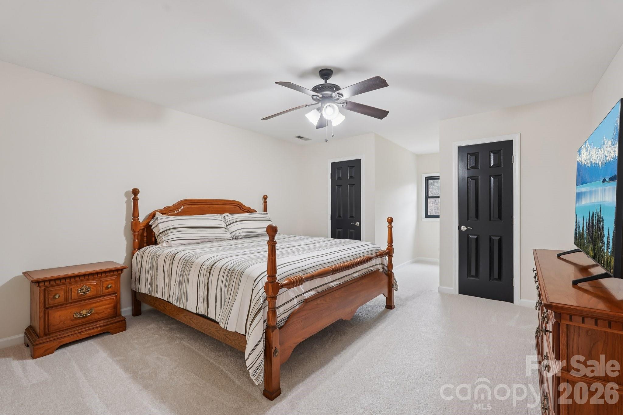 11655 Terrill Ridge Drive Davidson, NC 28036 - Photo 27 of 40 a bedroom with a bed and a chandelier