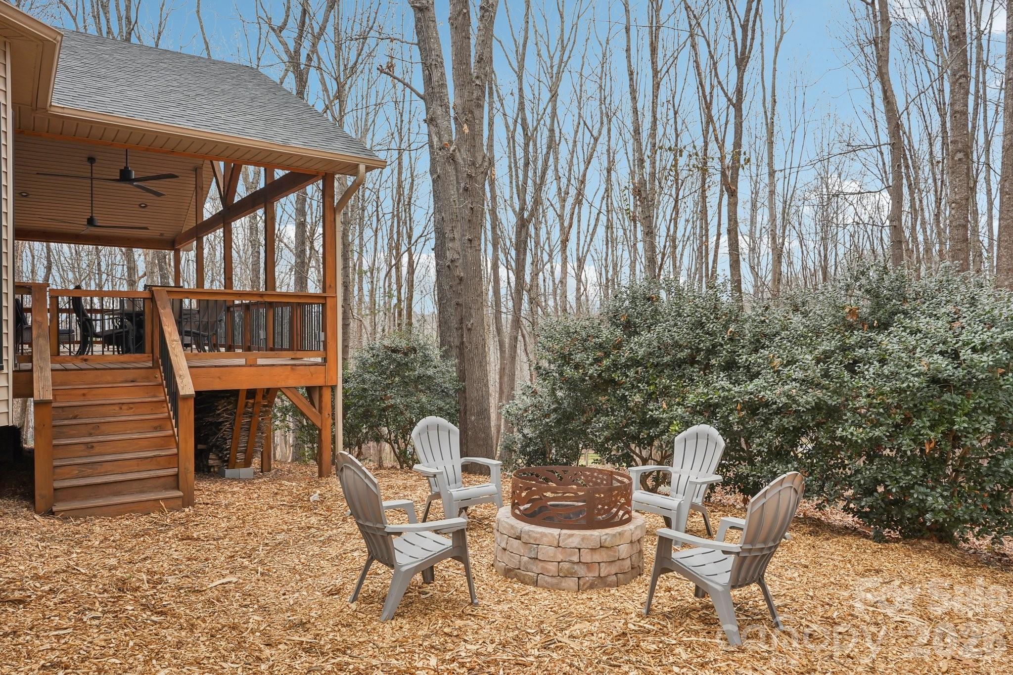 11655 Terrill Ridge Drive Davidson, NC 28036 - Photo 35 of 40 a patio with table and chairs and potted plants