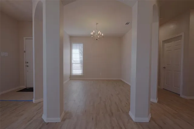 wooden floor in an empty room with a gallery