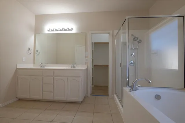 a bathroom with a bathtub shower and a sink