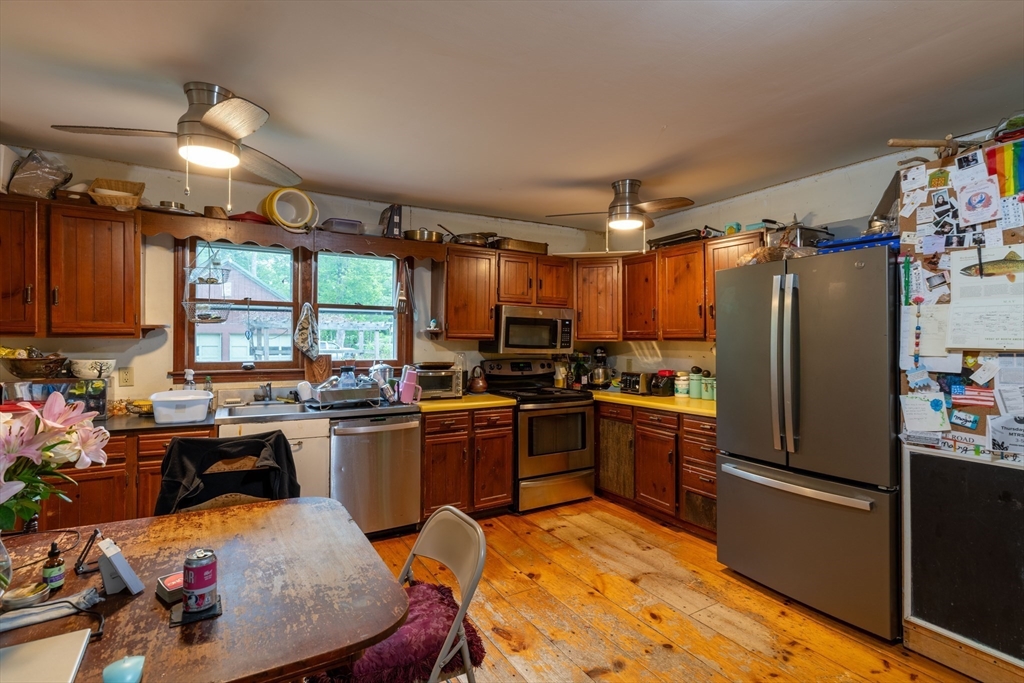 425 Dingle Road Worthington, MA 01098 - Photo 7 of 32 a kitchen with stainless steel appliances granite countertop a refrigerator a sink dishwasher a stove and white countertops with wooden floor