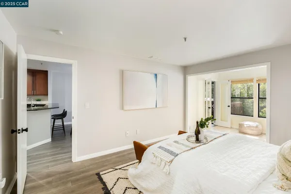 a bedroom with a bed and wooden floor