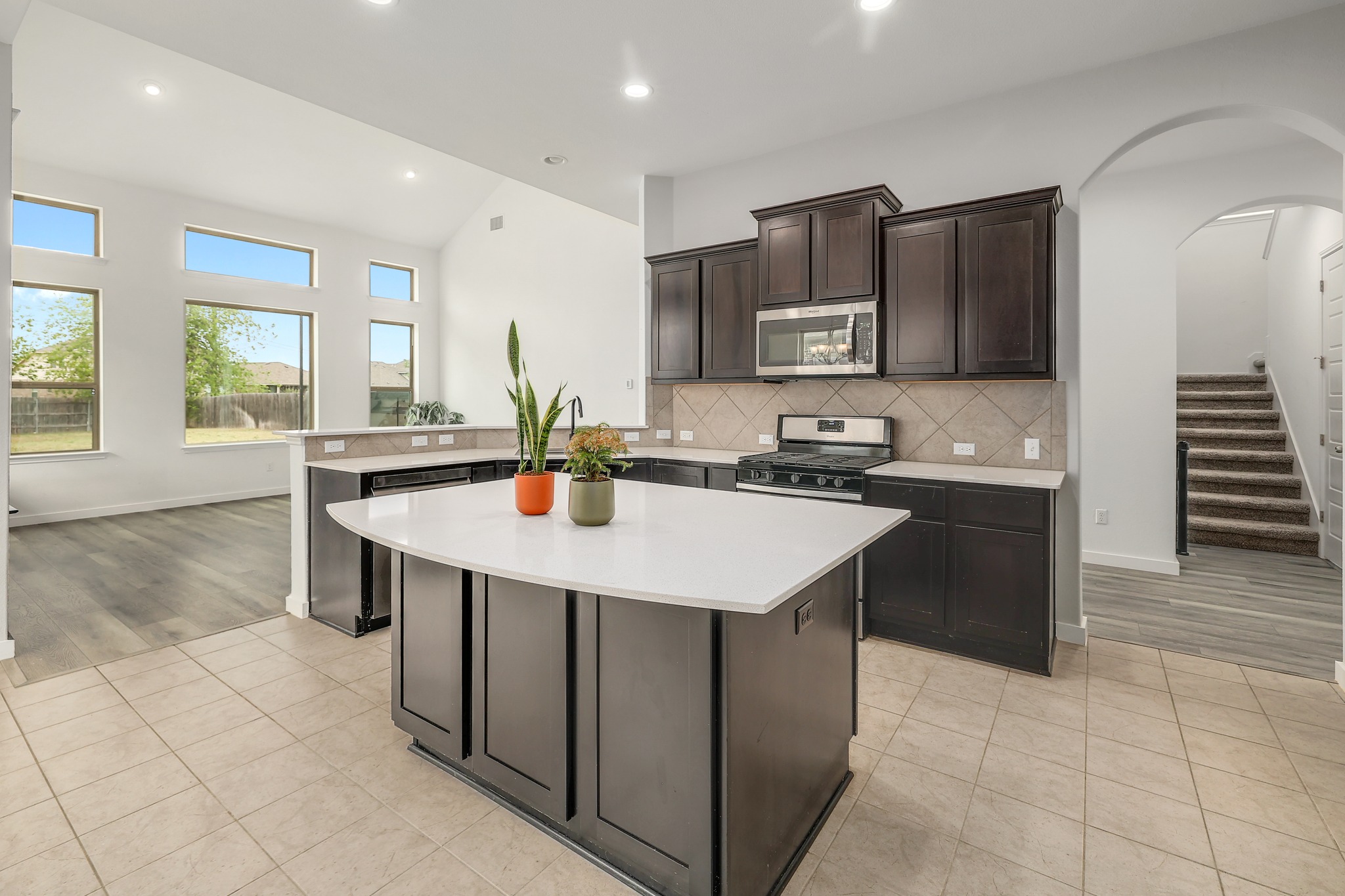 17309 Silent Harbor Loop Pflugerville, TX 78660 - Photo 11 of 38 a kitchen with stainless steel appliances a sink a stove a microwave and cabinets