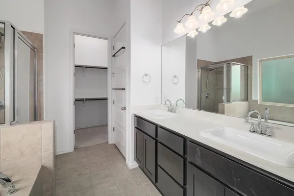 a bathroom with a double vanity sink and a mirror