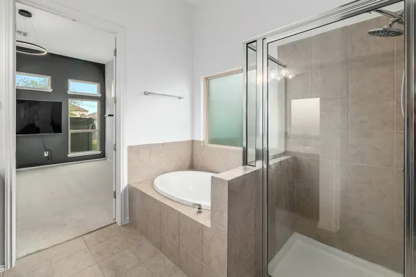 a bathroom with a tub and shower
