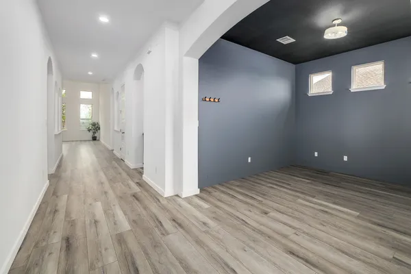 a view of a livingroom with wooden floor and stairs
