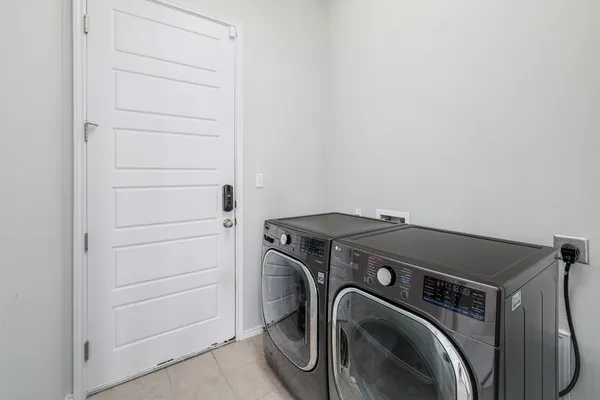 a view of a storage & utility room with dryer and washer