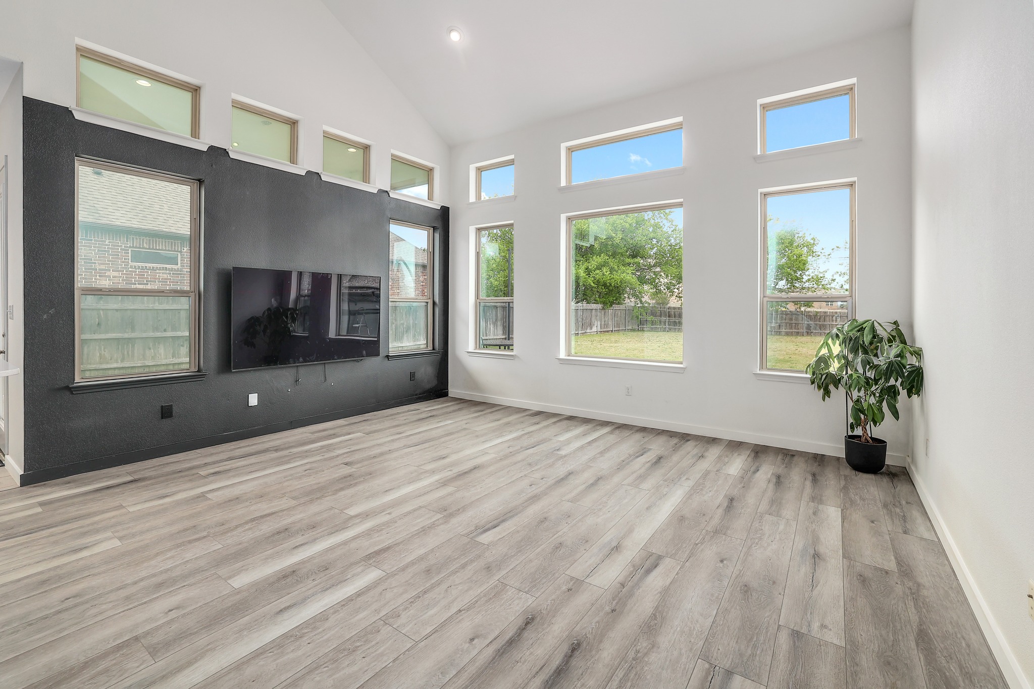 17309 Silent Harbor Loop Pflugerville, TX 78660 - Photo 3 of 38 a view of an empty room with a window and wooden floor