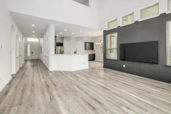 a view of a living room with kitchen furniture and a flat screen tv