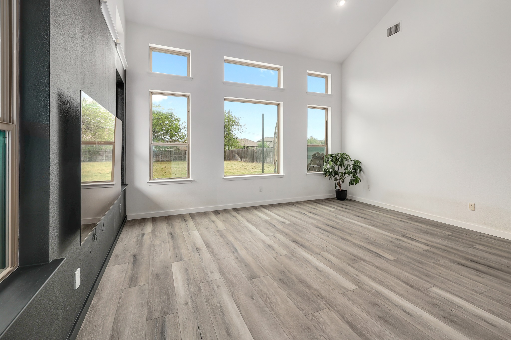 17309 Silent Harbor Loop Pflugerville, TX 78660 - Photo 5 of 38 a view of an empty room with a window and wooden floor
