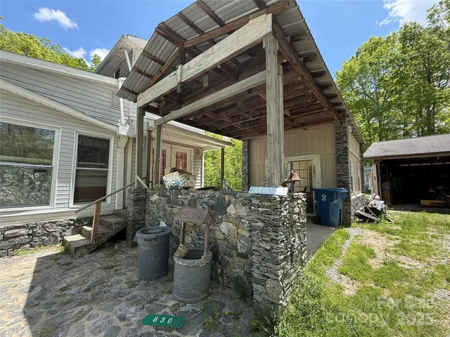 a view of a porch with furniture and a fire pit
