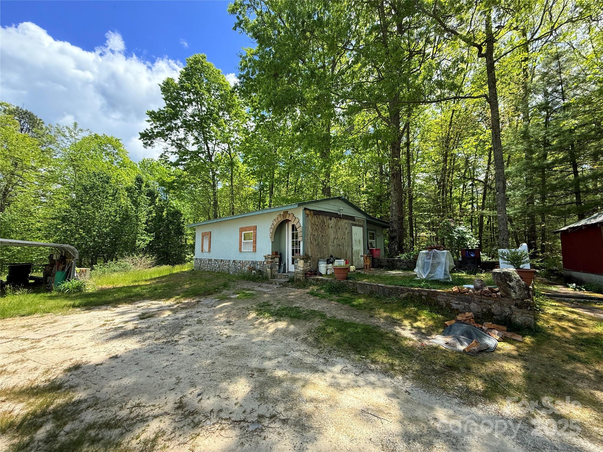 630 Deerchase Circle Cedar Mountain, NC 28718 - Photo 7 of 18 a view of a house with a yard and trees