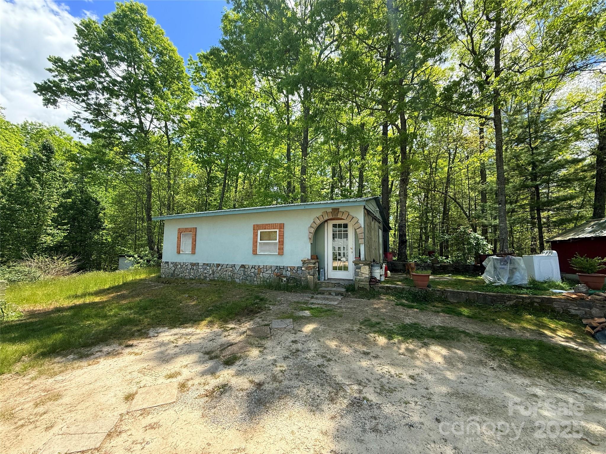630 Deerchase Circle Cedar Mountain, NC 28718 - Photo 8 of 18 a view of a house with a yard and large trees
