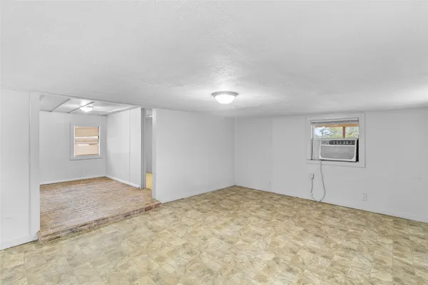 an empty room with a empty space and windows