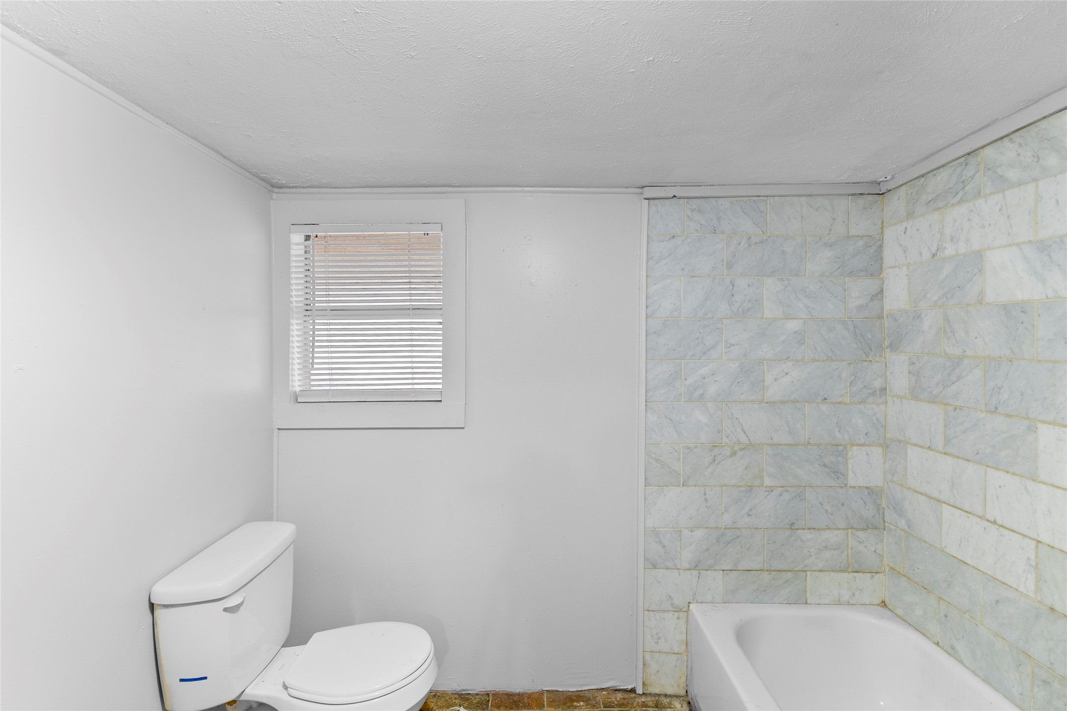 31C Jackson Road, Unit C Huntsville, TX 77320 - Photo 10 of 16 a white toilet sitting next to a bath tub