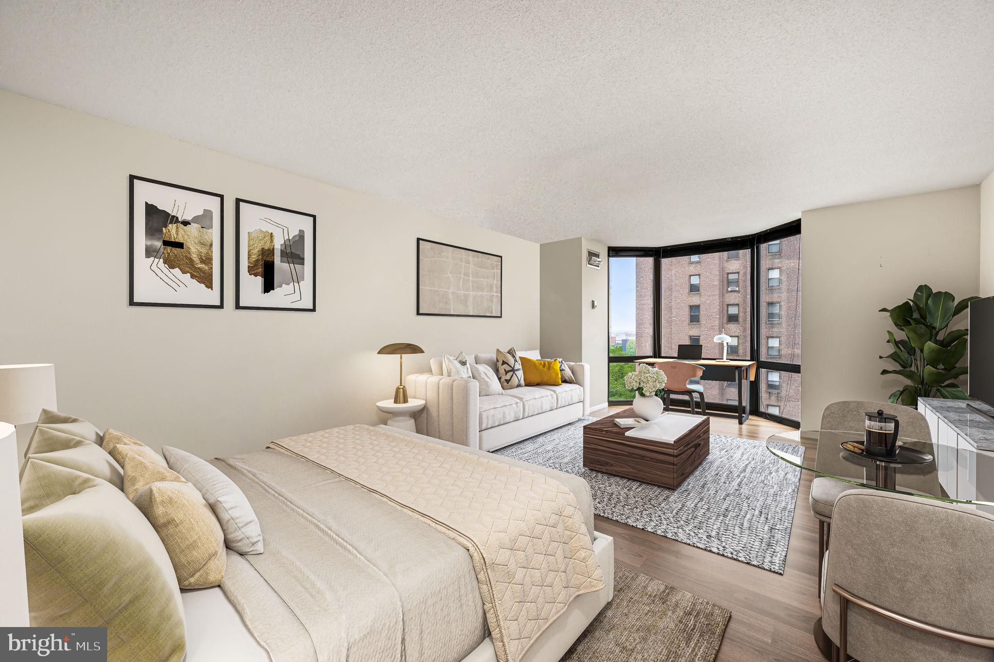2018 Walnut Street, Unit 15M Philadelphia, PA 19103 - Photo 1 of 31 a bedroom with furniture and a large window