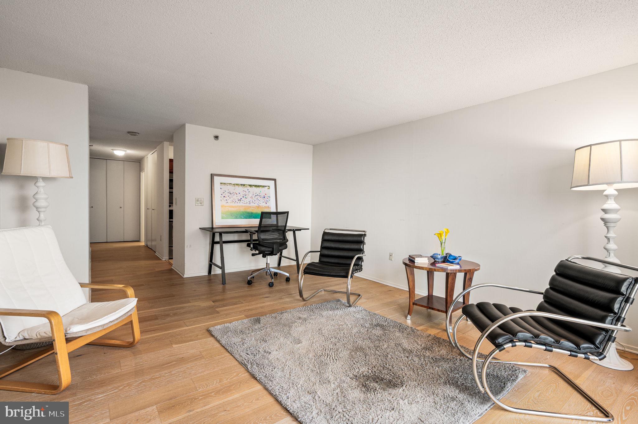 2018 Walnut Street, Unit 15M Philadelphia, PA 19103 - Photo 3 of 31 a living room with furniture a rug and a table