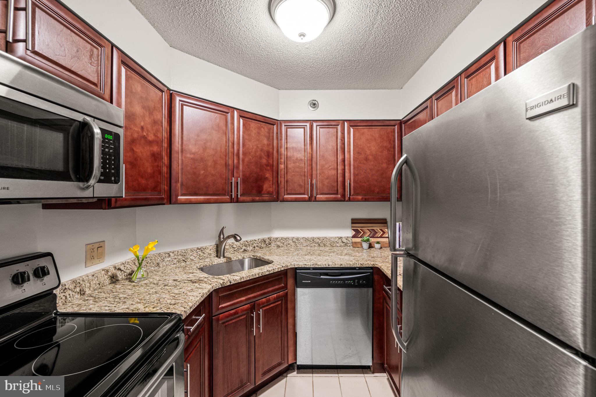 2018 Walnut Street, Unit 15M Philadelphia, PA 19103 - Photo 6 of 31 a kitchen with stainless steel appliances granite countertop a sink stove and cabinets