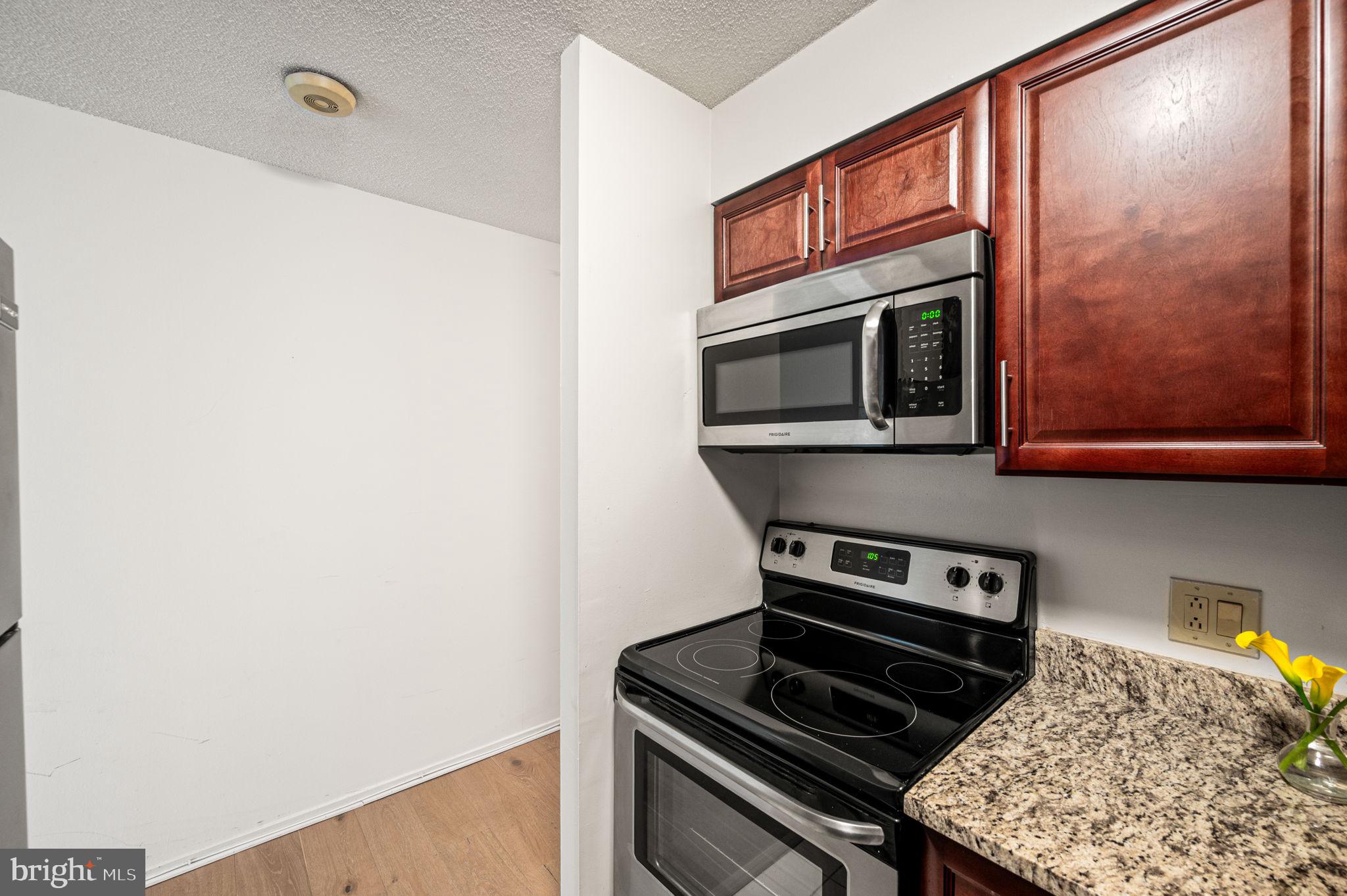2018 Walnut Street, Unit 15M Philadelphia, PA 19103 - Photo 7 of 31 a kitchen with a stove and a microwave