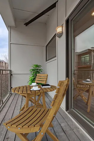 a view of balcony with wooden floor