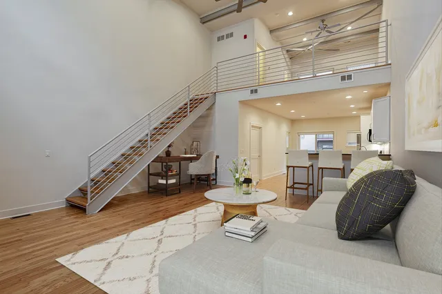 a living room with furniture and a chandelier