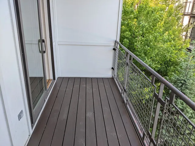 a view of balcony with wooden floor