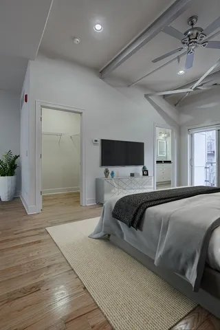 a bedroom with a large bed and a chandelier