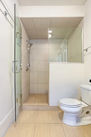 a bathroom with a toilet and a shower