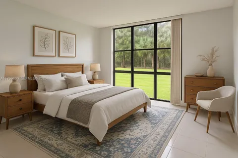 a bedroom with a bed and a large window
