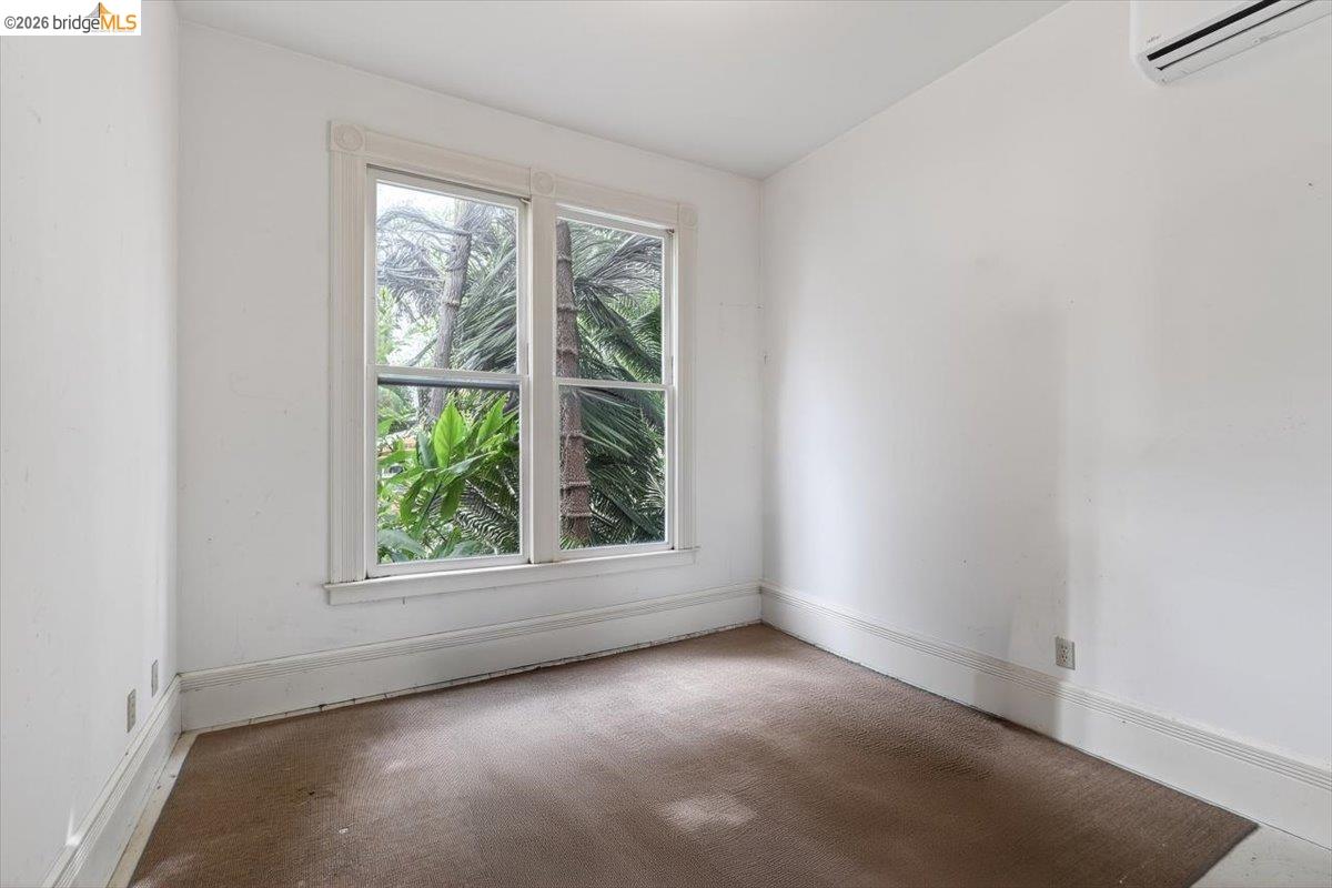 1013 Addison Street Berkeley, CA 94710 - Photo 18 of 57 Carpeted spare room featuring a wall mounted mini split and baseboards