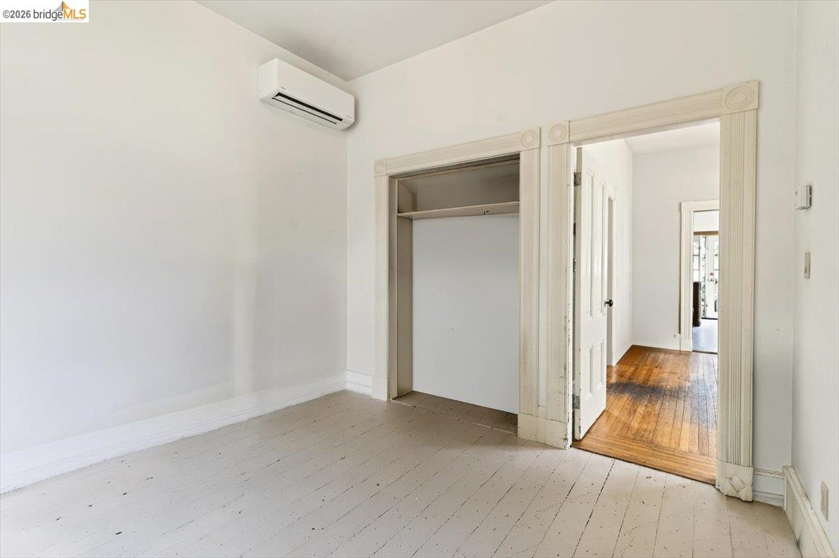 1013 Addison Street Berkeley, CA 94710 - Photo 20 of 57 Unfurnished bedroom with light wood-type flooring, a wall mounted mini split, and a closet