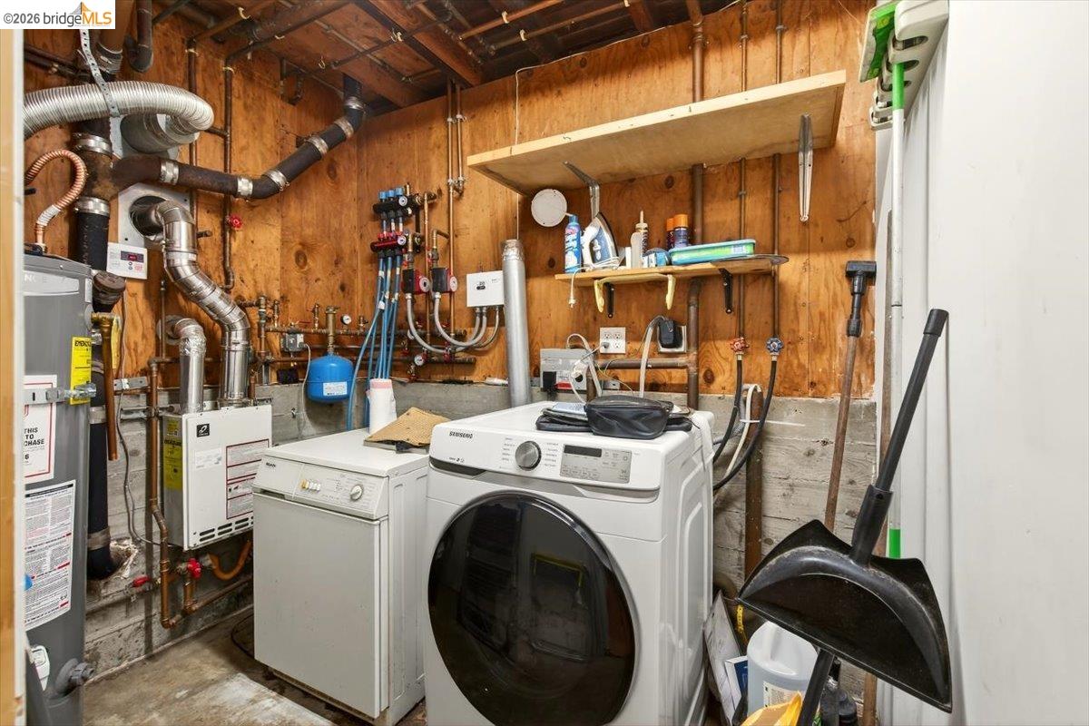 1013 Addison Street Berkeley, CA 94710 - Photo 46 of 57 Laundry area featuring unfinished concrete floors, wood walls, water heater, a heating unit, and independent washer and dryer