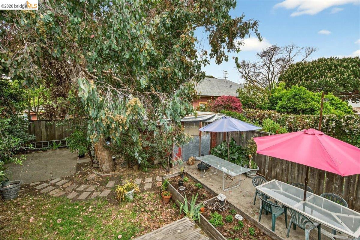 1013 Addison Street Berkeley, CA 94710 - Photo 48 of 57 Fenced backyard featuring a patio, outdoor dining space, and a vegetable garden