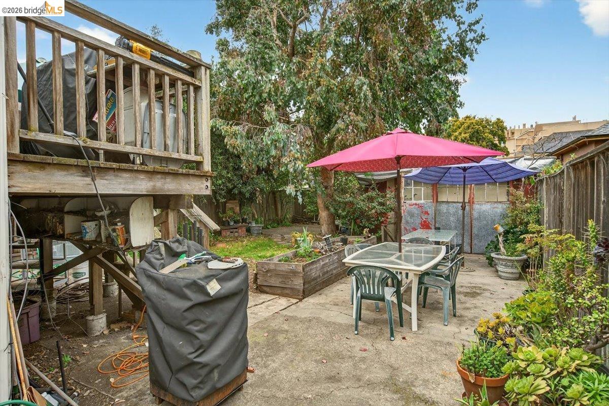 1013 Addison Street Berkeley, CA 94710 - Photo 50 of 57 Fenced backyard with outdoor dining area, a vegetable garden, a patio area, and a grill