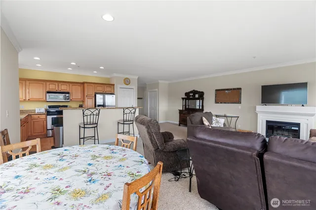 a living room with furniture a fireplace and kitchen view