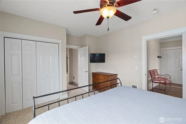 a bedroom with furniture and a flat screen tv