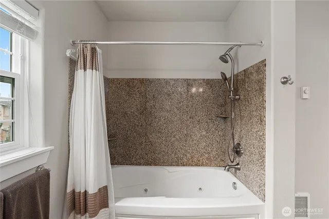 a bathroom with a shower and a bath tub