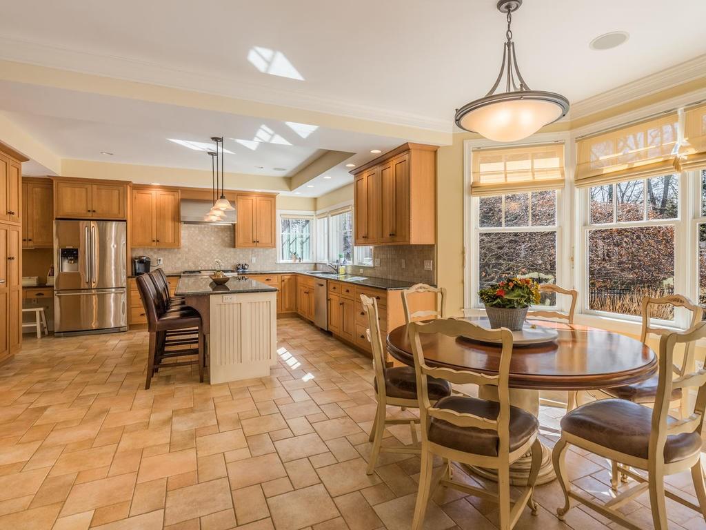 5 Saddle Club Road Lexington, MA 02420 - Photo 12 of 42 a dining table with chairs and kitchen view