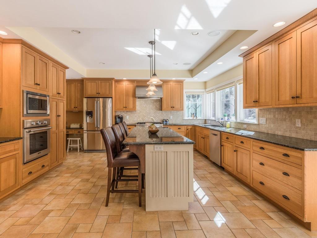 5 Saddle Club Road Lexington, MA 02420 - Photo 15 of 42 a kitchen with stainless steel appliances granite countertop a stove top oven a sink dishwasher and a refrigerator