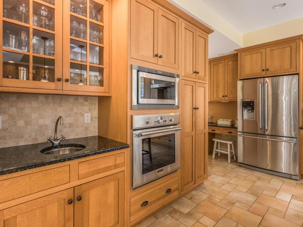5 Saddle Club Road Lexington, MA 02420 - Photo 17 of 42 a kitchen with granite countertop a stove top oven and refrigerator