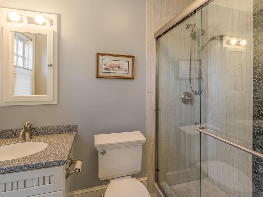 5 Saddle Club Road Lexington, MA 02420 - Photo 30 of 42 a bathroom with a granite countertop sink toilet and shower