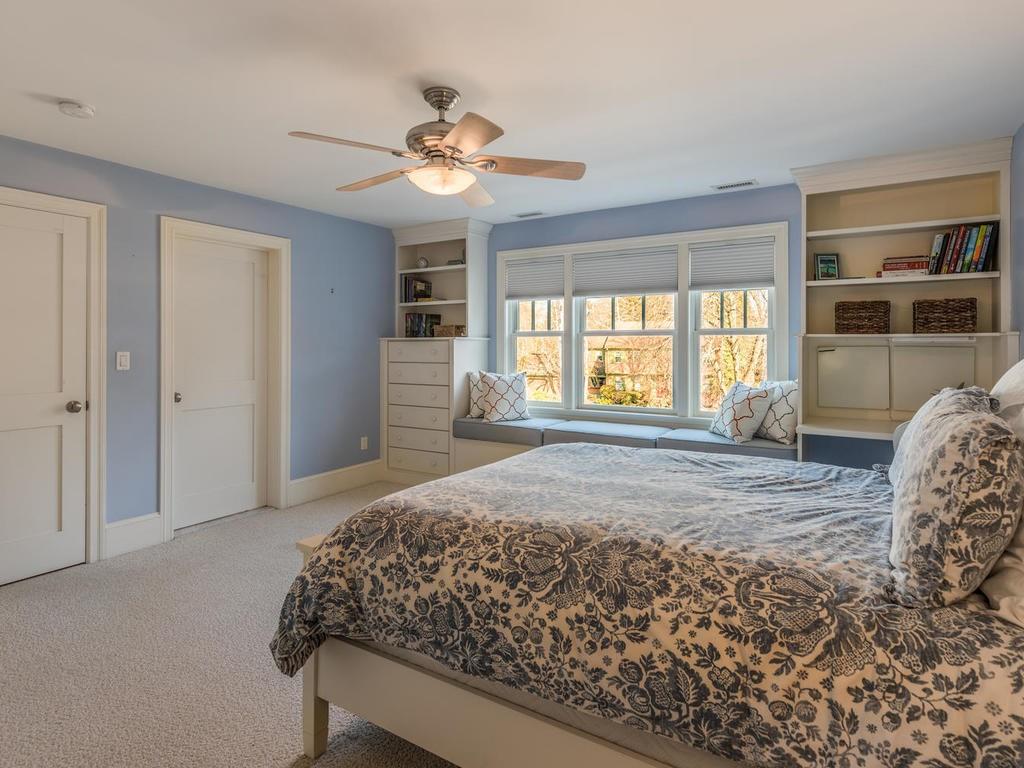 5 Saddle Club Road Lexington, MA 02420 - Photo 32 of 42 a bedroom with a bed and a large window