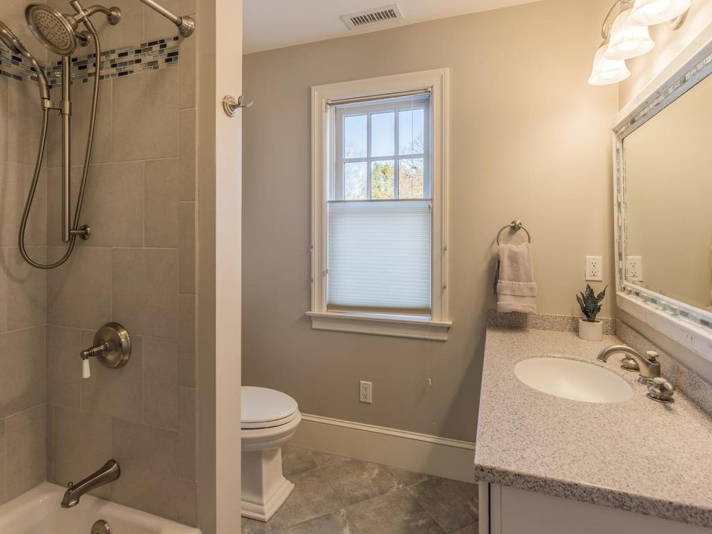 5 Saddle Club Road Lexington, MA 02420 - Photo 33 of 42 a bathroom with a granite countertop sink toilet and shower