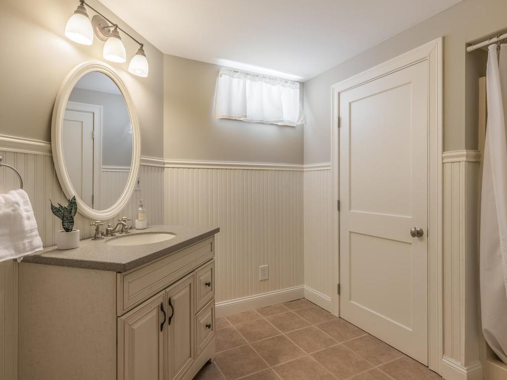 5 Saddle Club Road Lexington, MA 02420 - Photo 37 of 42 a bathroom with a granite countertop sink a toilet and a mirror
